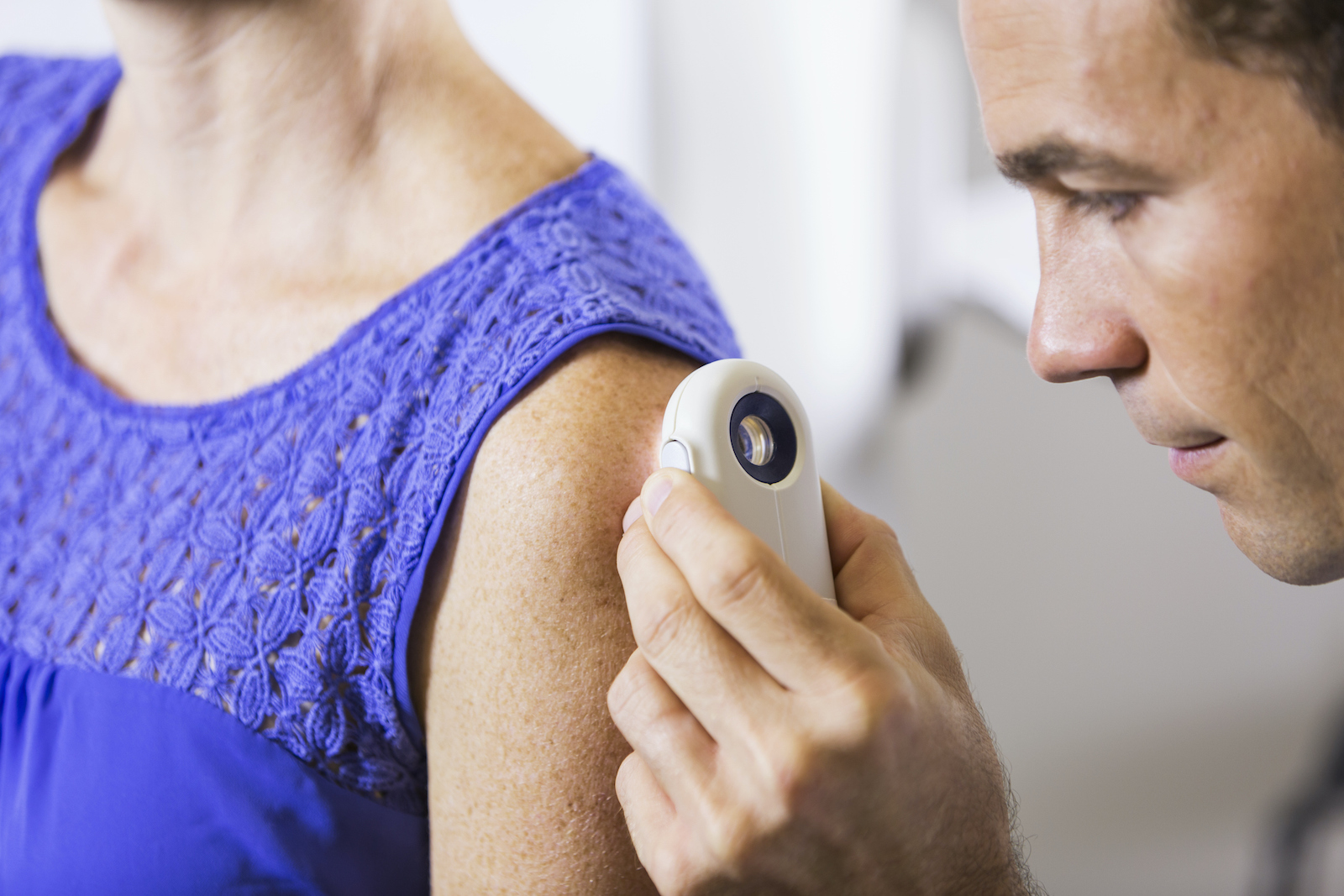 Dermatologist examining patient looking for skin cancer